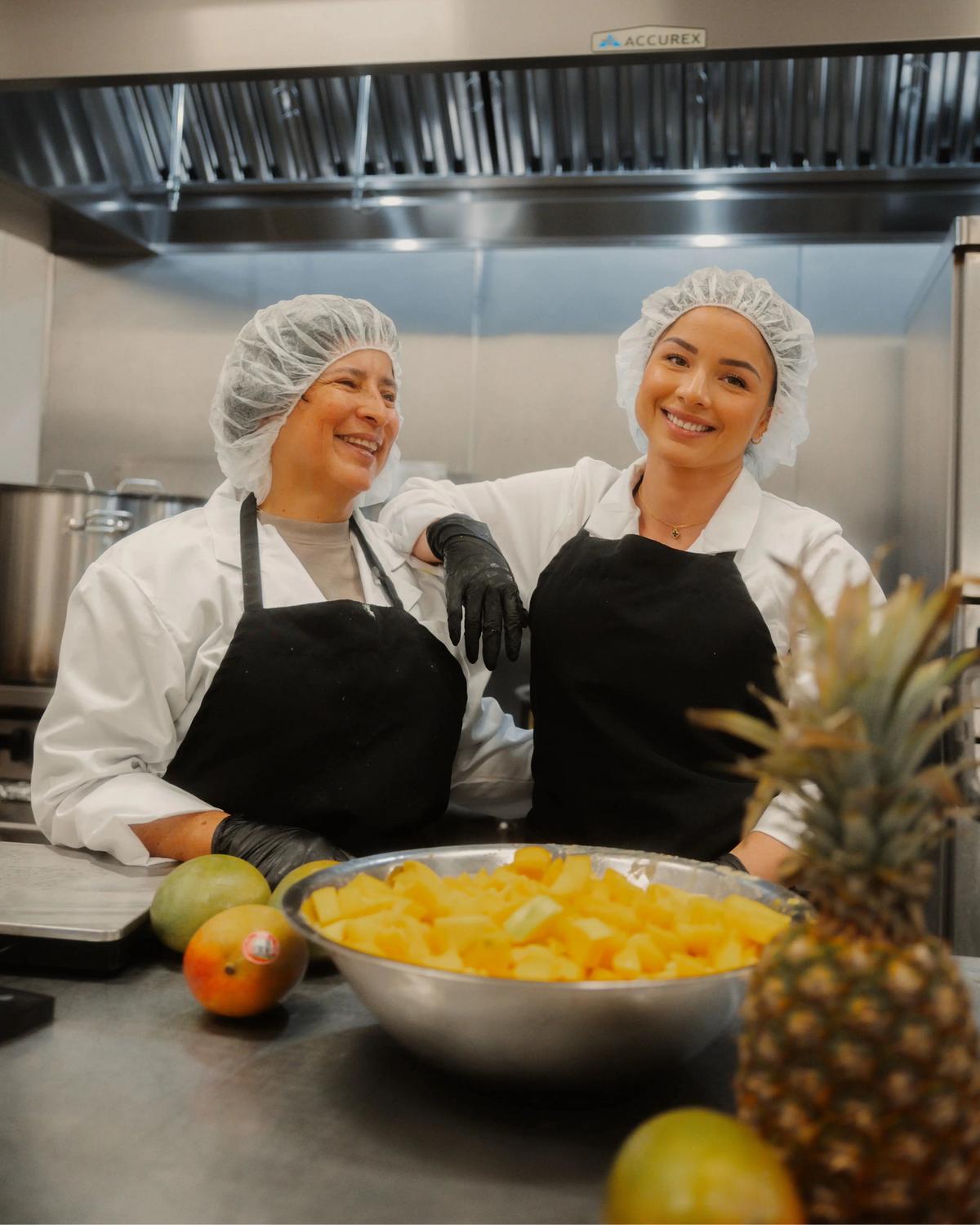 Founders of Nusauces doing a production bottles in a kitchen with fruits